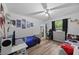 Fun ' bedroom with two beds, desks, wood-look floors, and space-themed decor at 3725 Grand Forks Dr, Land O Lakes, FL 34639