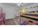 Playful bedroom featuring a bunk bed and a whimsical unicorn mural on the wall at 3725 Grand Forks Dr, Land O Lakes, FL 34639