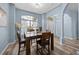 Cozy dining space with modern lighting and a clear view to the home's entrance at 3725 Grand Forks Dr, Land O Lakes, FL 34639