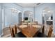 Charming dining area with wood table and chairs, and an open view of the living spaces at 3725 Grand Forks Dr, Land O Lakes, FL 34639