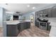 Modern kitchen with stainless steel appliances, gray cabinets, and marble countertops offers a sleek design at 3725 Grand Forks Dr, Land O Lakes, FL 34639