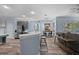 Open layout showcasing kitchen, breakfast bar and dining area with lots of natural light and modern finishes at 3725 Grand Forks Dr, Land O Lakes, FL 34639