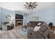 Relaxing living room with a fireplace, comfortable seating, and modern decor at 3725 Grand Forks Dr, Land O Lakes, FL 34639