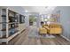 Bright living room with stylish shelving unit and an open view of the backyard pool area at 3725 Grand Forks Dr, Land O Lakes, FL 34639