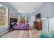 This main bedroom features wood floors, blue walls, two dressers and windows for natural light at 3725 Grand Forks Dr, Land O Lakes, FL 34639