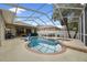 Lovely backyard pool and spa enclosed in a screen with seating, creating a peaceful oasis at 3725 Grand Forks Dr, Land O Lakes, FL 34639