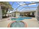 Backyard pool and spa are surrounded by a screened enclosure offering privacy and a tropical feel at 3725 Grand Forks Dr, Land O Lakes, FL 34639