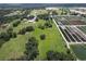 Wide aerial view showcasing farmland with lush green fields, buildings, and meticulously organized row crops at 4106 Old Mulberry Rd, Plant City, FL 33567