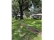 Expansive backyard with mature trees and green lawn, and a storage building at 4106 Old Mulberry Rd, Plant City, FL 33567
