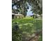 Wide open backyard with sheds, a barn, and trees, surrounded by a chain link fence at 4106 Old Mulberry Rd, Plant City, FL 33567