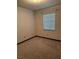 An empty bedroom showcases a window, carpet, and blank white walls at 4106 Old Mulberry Rd, Plant City, FL 33567