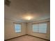 An empty bedroom with carpet, white walls, and two windows with blinds at 4106 Old Mulberry Rd, Plant City, FL 33567
