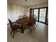 A dining room with chandelier, wood table, 6 chairs and glass doors with curtains at 4106 Old Mulberry Rd, Plant City, FL 33567