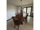 A dining room with chandelier, wood table, 6 chairs and glass doors with curtains at 4106 Old Mulberry Rd, Plant City, FL 33567