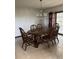 A dining room with chandelier, wood table, 6 chairs and glass doors with curtains at 4106 Old Mulberry Rd, Plant City, FL 33567