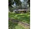 Lovely single-story brick home with manicured front lawn and mature trees at 4106 Old Mulberry Rd, Plant City, FL 33567