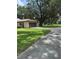 Detached garage with ample parking space and green lawn at 4106 Old Mulberry Rd, Plant City, FL 33567