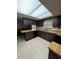 Functional kitchen with ample wood cabinets, black appliances, and a bright skylight offering plenty of natural light at 4106 Old Mulberry Rd, Plant City, FL 33567