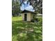 Quaint shed surrounded by lush green lawn and mature trees at 4106 Old Mulberry Rd, Plant City, FL 33567