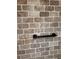 Close-up of a brick-tiled shower with a black grab bar installed at 4106 Old Mulberry Rd, Plant City, FL 33567
