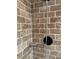 Close-up of custom tiled shower with sleek, modern fixtures and a built-in shelf for convenience at 4106 Old Mulberry Rd, Plant City, FL 33567