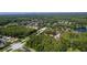 Aerial view showcasing a community surrounded by lush greenery and serene lakes at 4117 Daventry Ln, Palm Harbor, FL 34685