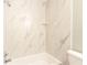 Bathroom featuring a tub and shower with marble-style tile surround at 4117 Daventry Ln, Palm Harbor, FL 34685