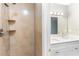 Updated bathroom featuring double sinks and decorative lighting at 4117 Daventry Ln, Palm Harbor, FL 34685