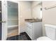 Bathroom featuring white vanity, granite countertop, with black tile floors and an open doorway at 4117 Daventry Ln, Palm Harbor, FL 34685