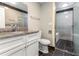 Bathroom with white cabinets, granite countertop, grey tile backsplash, and a glass shower door at 4117 Daventry Ln, Palm Harbor, FL 34685