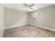 Bedroom featuring hard wood floors, a fan, and a window with partial view at 4117 Daventry Ln, Palm Harbor, FL 34685