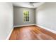 Bedroom with hardwood floors, neutral paint, and window at 4117 Daventry Ln, Palm Harbor, FL 34685