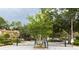 Gated community entrance featuring lush landscaping, mature trees, and black metal gates at 4117 Daventry Ln, Palm Harbor, FL 34685