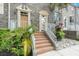 Charming multi-story townhome with brick facade, lush landscaping, and inviting front entrance at 4117 Daventry Ln, Palm Harbor, FL 34685
