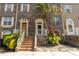 Charming multi-story townhome with brick facade, lush landscaping, and inviting front entrance at 4117 Daventry Ln, Palm Harbor, FL 34685