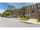 Brick townhome with manicured lawn and landscaping, showing driveway and front parking spaces at 4117 Daventry Ln, Palm Harbor, FL 34685