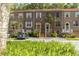 Brick townhome with neutral shutters, well-maintained landscaping, and parking in front of unit at 4117 Daventry Ln, Palm Harbor, FL 34685