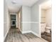 Hallway showcasing wood-look vinyl floors, decorative trim, and easy access to the bathroom at 4117 Daventry Ln, Palm Harbor, FL 34685