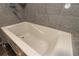 Close up of the jacuzzi tub with gray tile surround at 4117 Daventry Ln, Palm Harbor, FL 34685