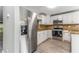 Close-up of the stainless-steel refrigerator in this kitchen with white cabinetry at 4117 Daventry Ln, Palm Harbor, FL 34685