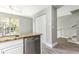 Updated kitchen featuring stainless steel dishwasher, granite countertops, and bright natural light at 4117 Daventry Ln, Palm Harbor, FL 34685