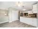 Kitchen with white cabinets, granite countertops, stainless steel appliances, and light grey vinyl flooring at 4117 Daventry Ln, Palm Harbor, FL 34685