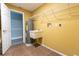 Laundry room featuring tile flooring, sink, washer, dryer, and storage racks at 4117 Daventry Ln, Palm Harbor, FL 34685