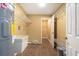 Laundry room featuring tile flooring, open doorway, washer, dryer, and storage racks at 4117 Daventry Ln, Palm Harbor, FL 34685