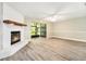 Living room featuring a brick fireplace, ceiling fan, and screened sliding doors to lanai at 4117 Daventry Ln, Palm Harbor, FL 34685