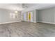 Open-concept living room with modern flooring, natural light, and easy access to the bathroom at 4117 Daventry Ln, Palm Harbor, FL 34685