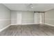 Spacious main bedroom with modern sliding barn door, ceiling fan, and neutral paint at 4117 Daventry Ln, Palm Harbor, FL 34685