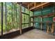 The screened porch is a perfect retreat with shelving and views of the backyard at 4117 Daventry Ln, Palm Harbor, FL 34685
