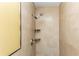 Tiled shower with mounted shower head and shampoo shelves at 4117 Daventry Ln, Palm Harbor, FL 34685
