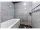 Shower with gray tile surround and jacuzzi tub at 4117 Daventry Ln, Palm Harbor, FL 34685